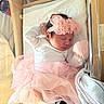 newborn, baby, sleeping, pink_tutu, headband, hospital_bassinet, white_clothing, mittens, blanket, soft_lighting, infant, cute, peaceful, resting, indoor, portrait, small, delicate, cozy, tulle