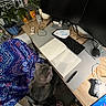Atlas is registered to the contest to win money with this photo: cat, chair, desk, notebook, keyboard, computer_mouse, monitor, blanket, plant, office, indoor, wooden_desk, pen, cable, potted_plant, footwear, person_feet, home_office, decor, stationery