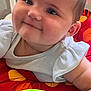 baby, smiling, face, child, toy, play_area, colorful, infant, close_up, cute, happy, skin, clothing, arm, indoor, seat, plastic_toy, cheeks, person, young