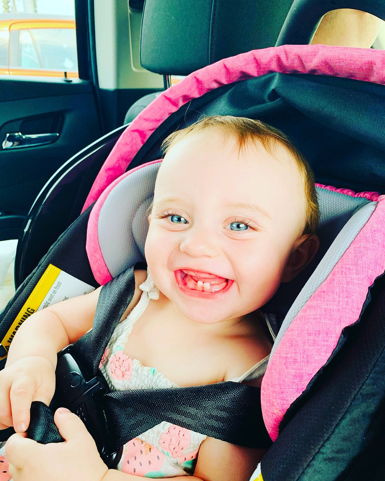 Violet is registered to the contest to win money with this photo: baby, baby_carriage, baby_in_car_seat, baby_toddler_clothing, car_seat, cheek, comfort, cool, facial_expression, hairstyle, happy, head, joy, mouth, person, pink, product, seat_belt, skin, smile
