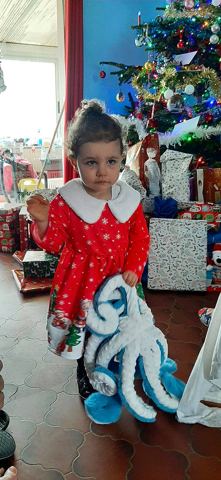 Maryam a rejoint le concours — aidez-le/la à gagner de superbes lots ! baby_toddler_clothing, blue, child, christmas, christmas_eve, event, facial_expression, fashion, fun, happy, holiday, leisure, person, pink, sitting, sleeve, standing, textile, toddler, tradition