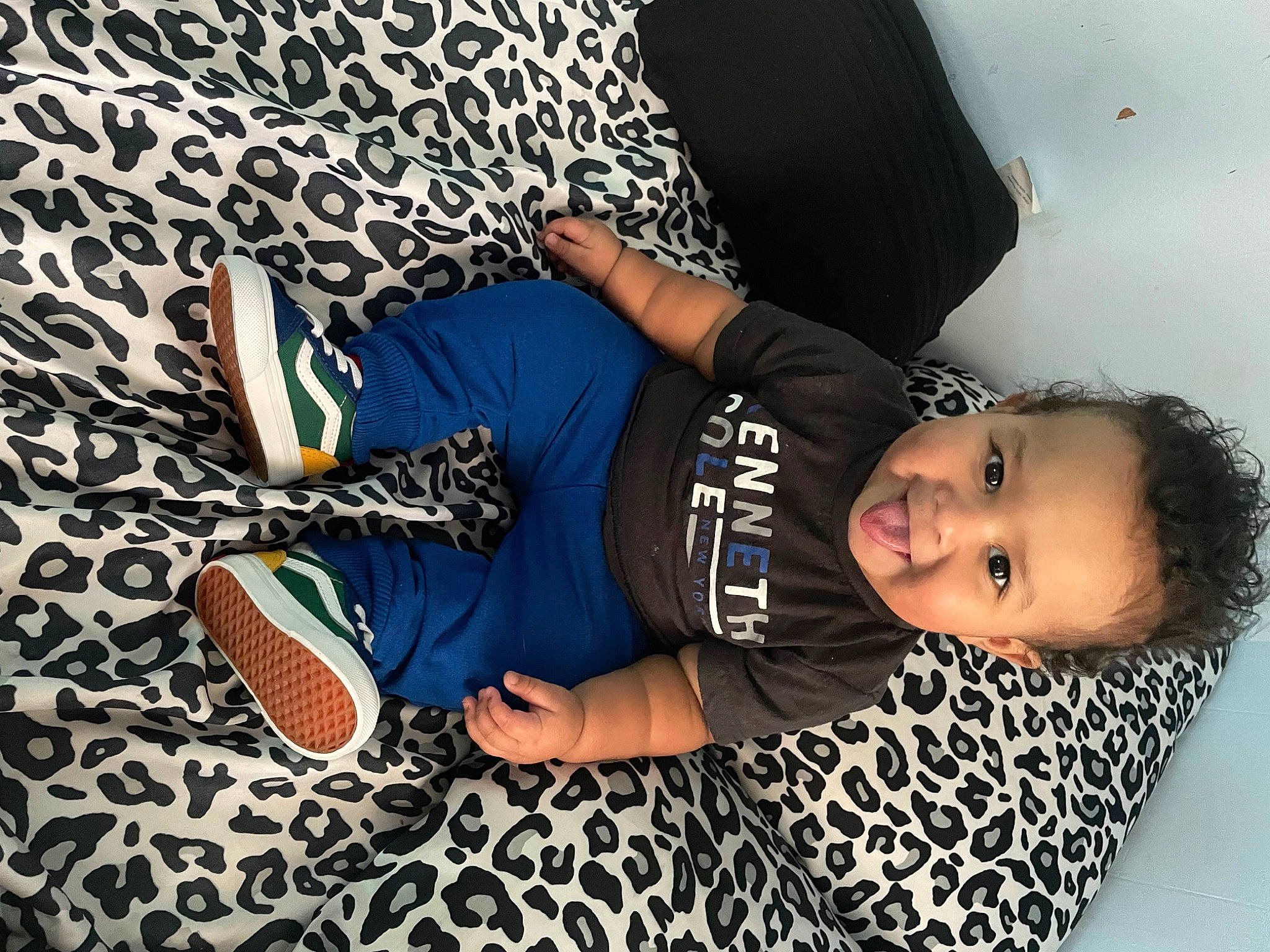 Kashton is registered to the contest to win money with this photo: elbow, electric_blue, flash_photography, flooring, font, fun, happy, hat, human_leg, joint, knee, pattern, person, sitting, sleeve, sneakers, sportswear, t_shirt, thigh, toddler