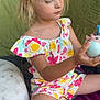 Séréna a rejoint le concours — aidez-le/la à gagner de superbes lots ! blonde_hair, candid, casual, child, colorful_clothing, curious, cushion, floral_pattern, girl, indoor, play, portrait, relaxed, side_view, sitting, sock, soft_light, tent, toy, young