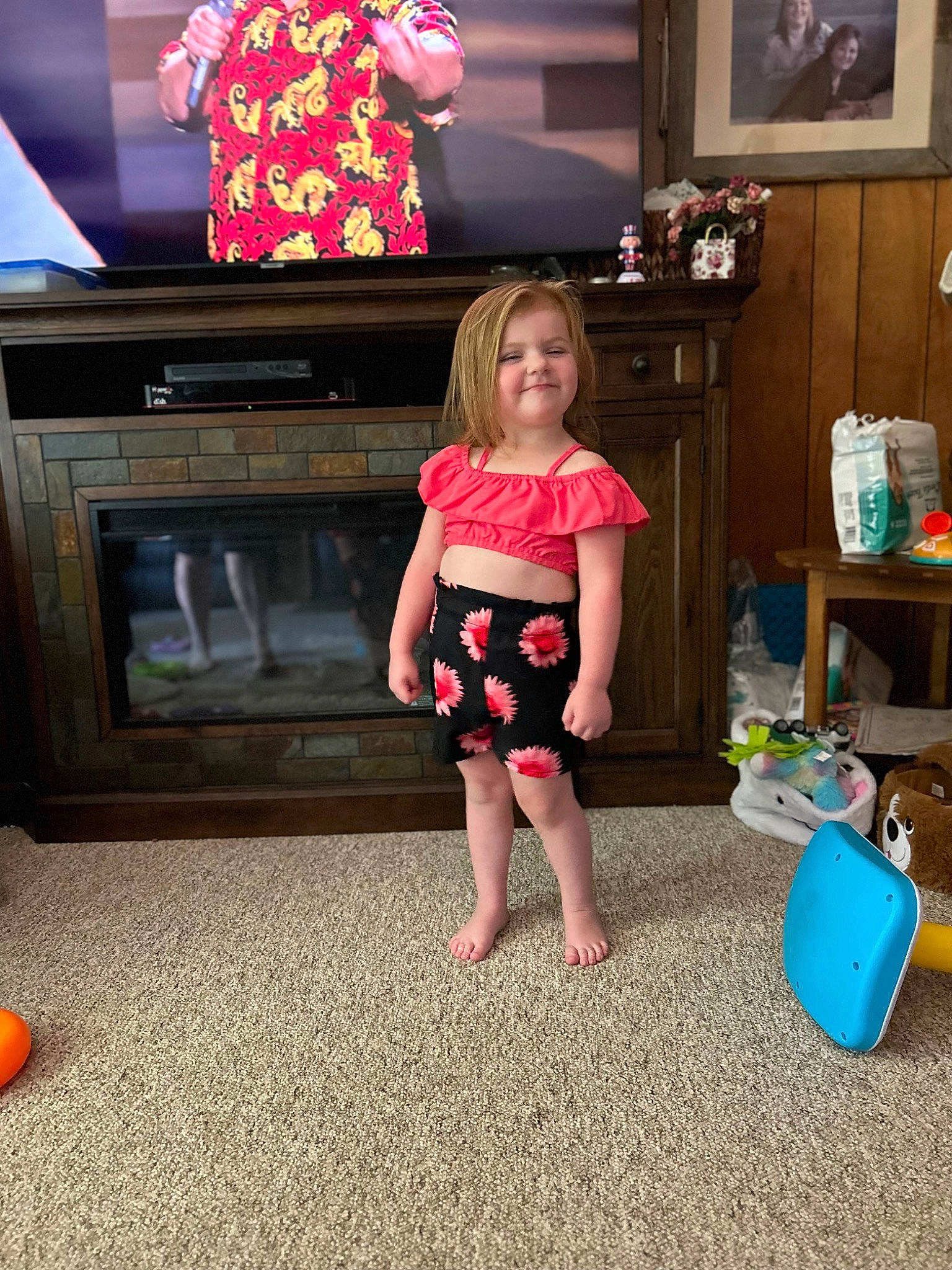 Kinzlee is registered to the contest to win money with this photo: child, display_device, fashion_design, flat_panel_display, flooring, fun, home_appliance, human_leg, joy, leisure, living_room, magenta, person, picture_frame, pink, play, room, television, television_set, toddler