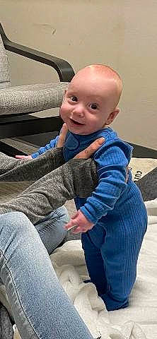 Oliver is registered to the contest to win money with this photo: baby, baby_toddler_clothing, cheek, child, comfort, denim, electric_blue, eye, finger, flooring, fun, gesture, happy, jeans, joy, person, sitting, sleeve, smile, thumb