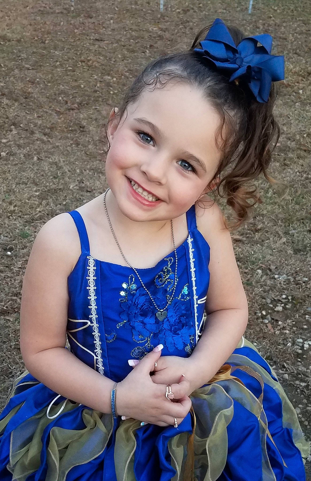 Makayli is registered to the contest to win money with this photo: baby_toddler_clothing, blue, child, child_model, costume, dress, electric_blue, fashion_accessory, grass, hair_accessory, happy, joy, pattern, person, photography, plant, sitting, smile, toddler