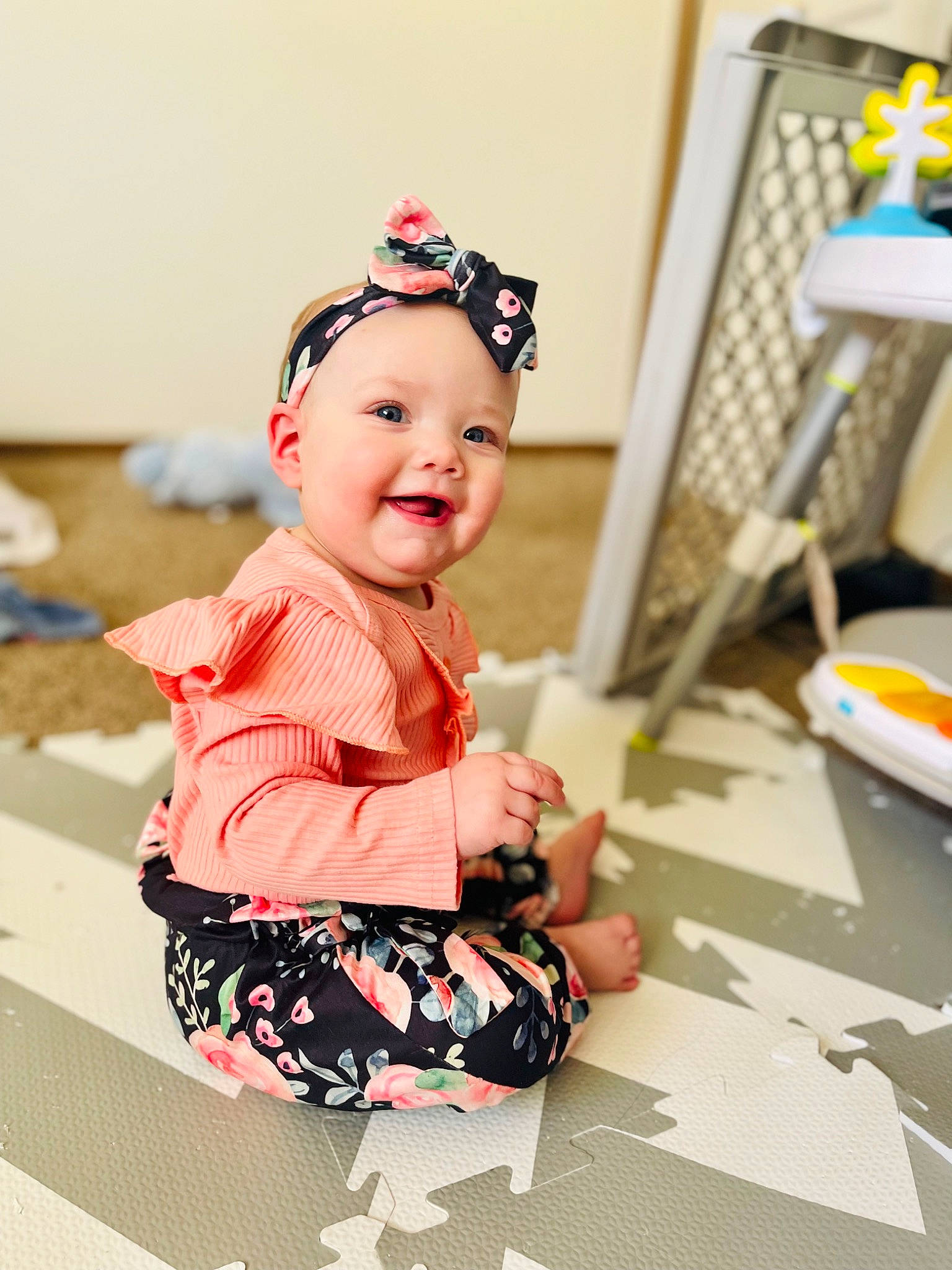 Isabella is registered to the contest to win money with this photo: baby, baby_toddler_clothing, child, design, eyewear, face, fashion_accessory, fashion_design, flooring, fun, happy, headband, headwear, pattern, peach, person, room, sitting, sleeve, smile