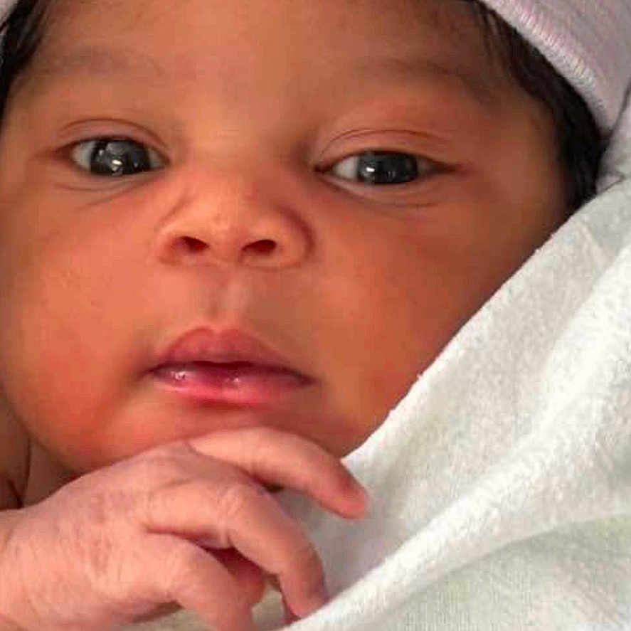 Kali is registered to the contest to win money with this photo: architecture, baby, blanket, bodypart, bonnet, building, cap, clothing, face, finger, hand, hat, head, hospital, newborn, person, photography, portrait, quilt, towel