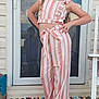 Heaven is registered to the contest to win money with this photo: child, girl, smile, pose, striped_clothing, pants, top, sandals, earrings, wreath, door, glass_door, doormat, rug, outdoor, home_entrance, hand_on_hip, long_hair, fashion, accessories