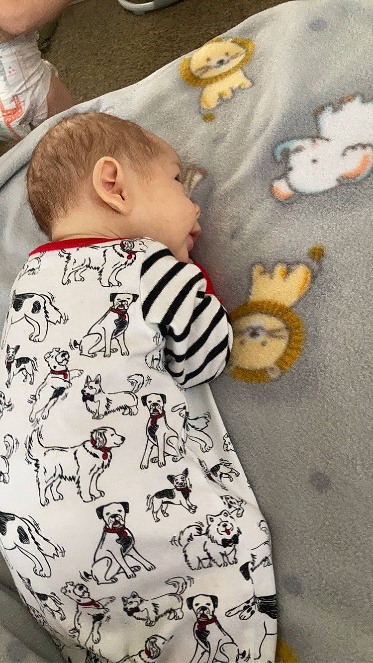 Brooks is registered to the contest to win money with this photo: baby, baby_products, baby_toddler_clothing, child, clothing, fashion_design, fur, linens, long_sleeved_t_shirt, mammal, outerwear, pattern, person, sitting, sleeve, t_shirt, textile, toddler, toy, vertebrate