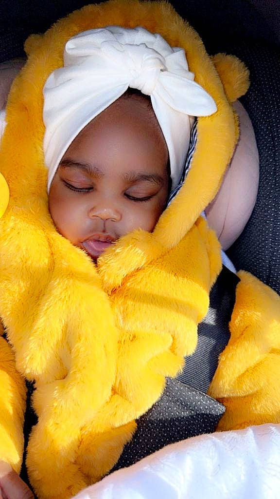 Eunice participe au concours pour gagner de l'argent avec cette photo : baby, baby_products, baby_safety, baby_sleeping, baby_toddler_clothing, cheek, comfort, eye, fun, hand, hat, headgear, headwear, linens, mouth, orange, outerwear, person, product, skin