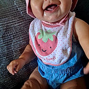 Alani joined the competition — help win amazing prizes! baby, child, smiling, bib, pink_hat, drool, blue_clothing, sitting, couch, happy, cute, indoor, face, person, infant, portrait, clothing, headwear, toddler, fun
