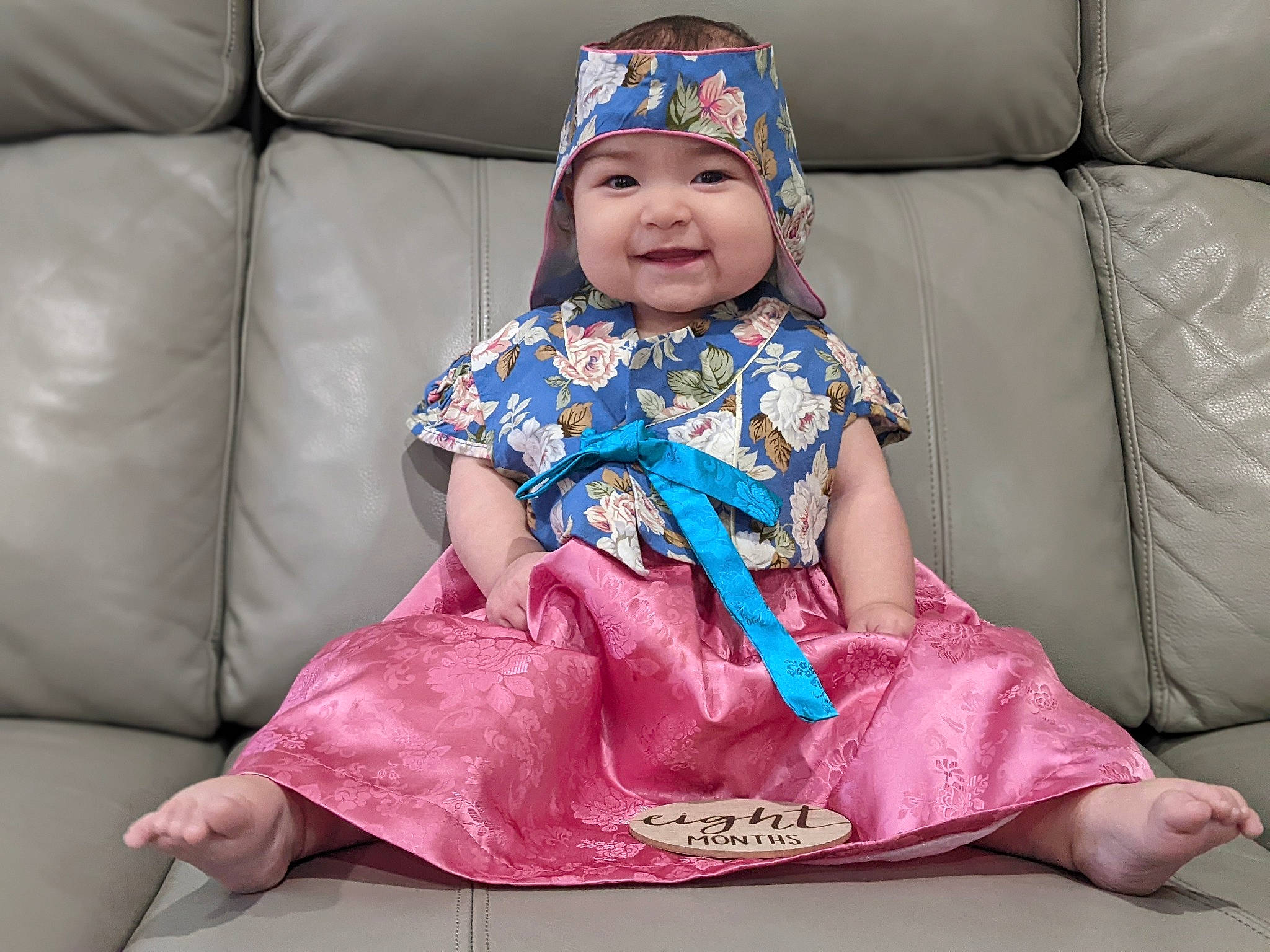 Isa joined the competition — help win amazing prizes! baby_toddler_clothing, blue, cap, child, comfort, costume_hat, couch, event, face, fun, happy, head, headwear, joy, magenta, person, pink, purple, sitting, skin