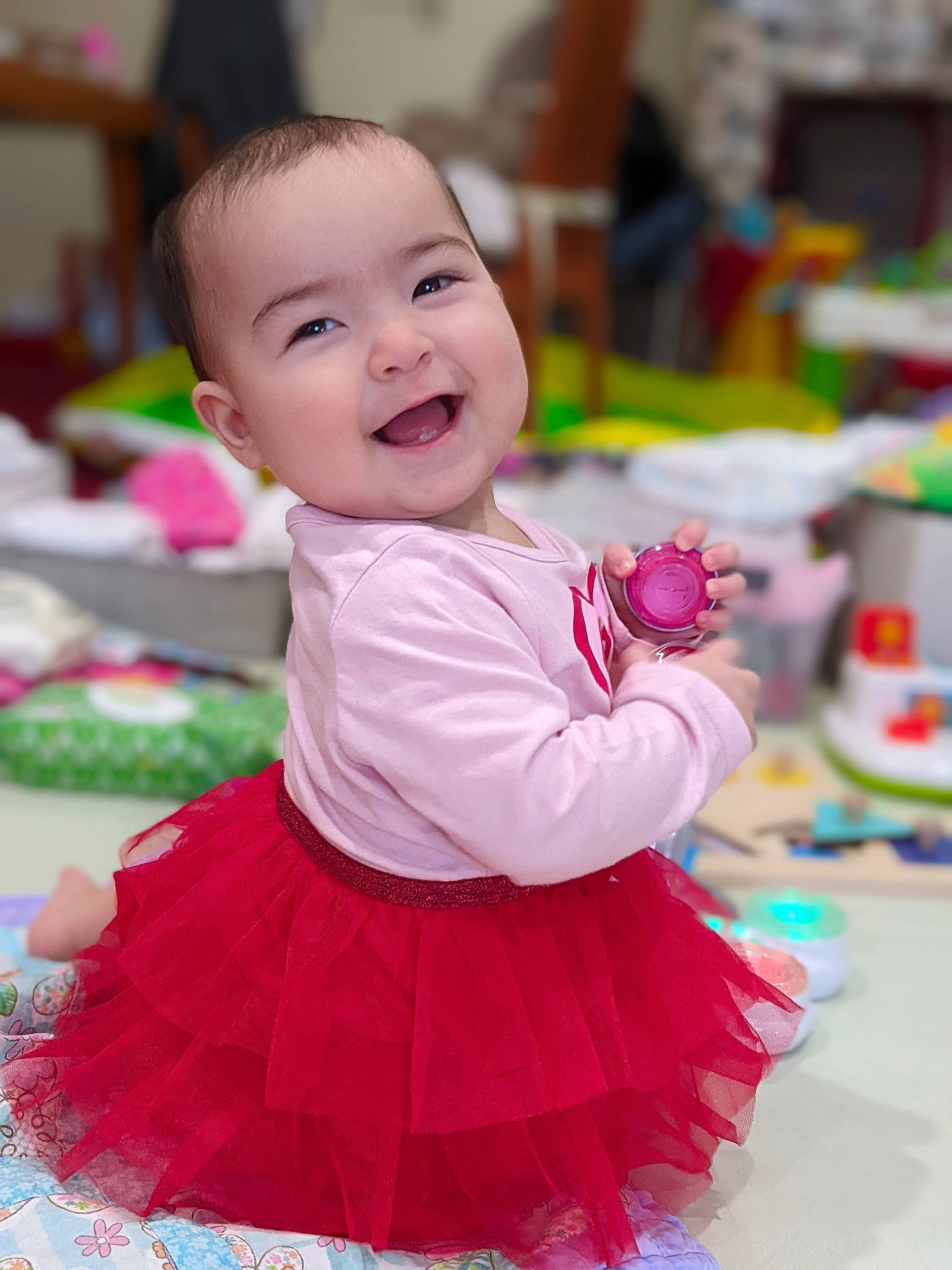 Isa is registered to the contest to win money with this photo: baby, baby_toddler_clothing, child, entertainment, event, fun, happy, joy, leisure, magenta, person, pink, play, product, purple, ruffle, skin, sleeve, smile, textile
