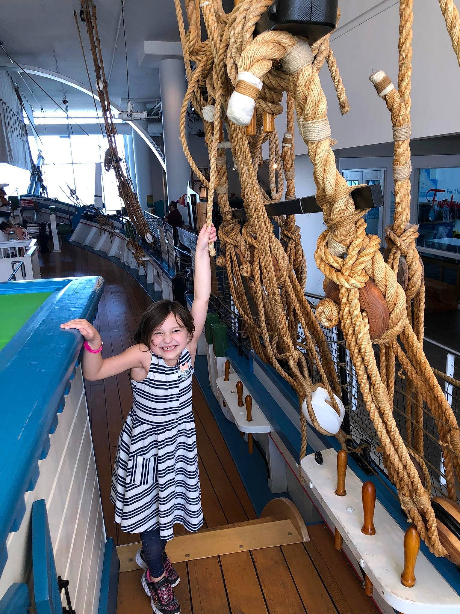 Camille is registered to the contest to win money with this photo: boat, boats_and_boating_equipment_and_supplies, boot, joy, leisure, mast, metal, naval_architecture, person, rope, sailing_ship, sandal, ship, ship_replica, shorts, smile, t_shirt, tall_ship, tourist_attraction, vehicle