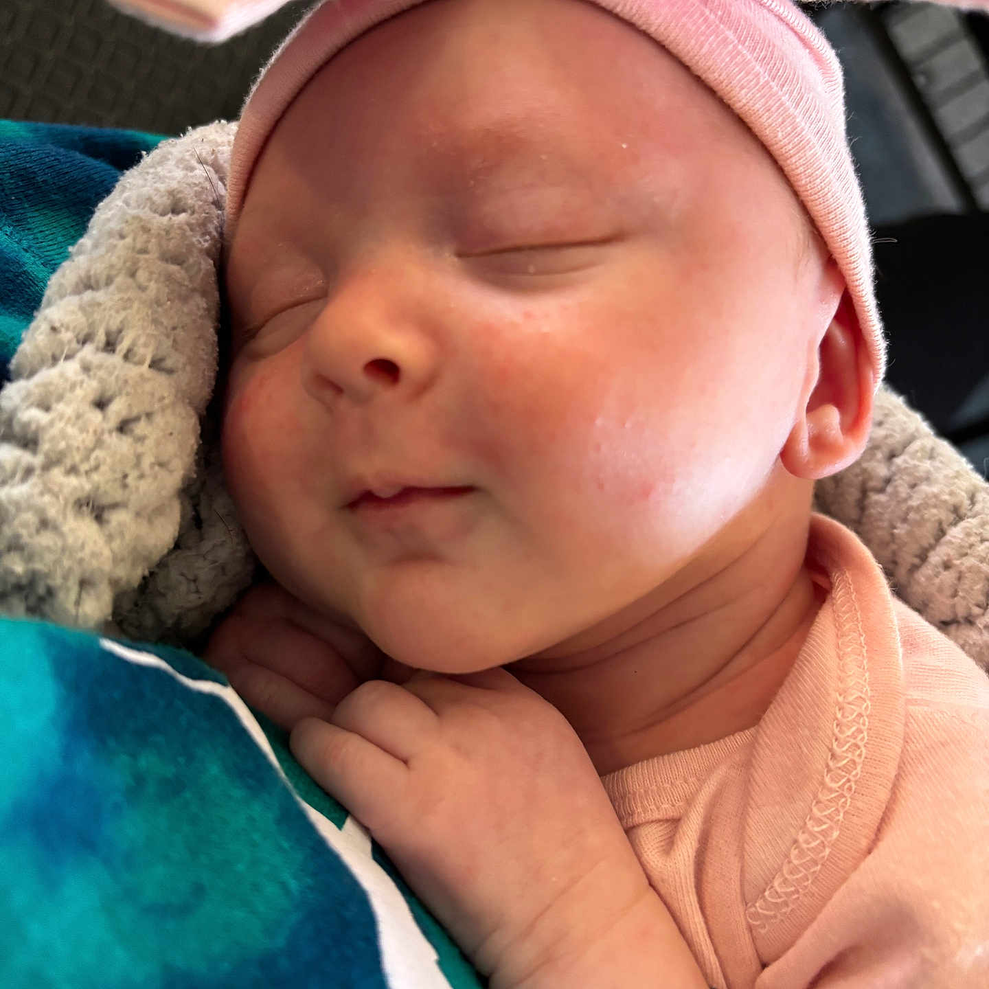 Lillian is registered to the contest to win money with this photo: baby, beanie, bodypart, bonnet, cap, clothing, face, finger, hand, hat, head, hood, hoodie, knitwear, newborn, person, photography, portrait, sleeping, towel