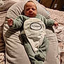 Mathéo participe au concours pour gagner de l'argent avec cette photo : baby, infant, child, onesie, pillow, bed, blanket, indoor, person, soft_fabric, sleepwear, cute, face, head, footed_pajamas, comfort, rest, newborn, relaxation, home