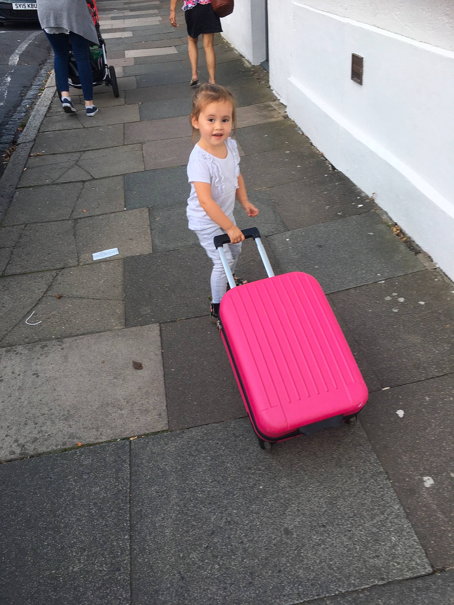 Leah-mae is registered to the contest to win money with this photo: asphalt, baggage, child, luggage_and_bags, person, pink, sidewalk, vacation