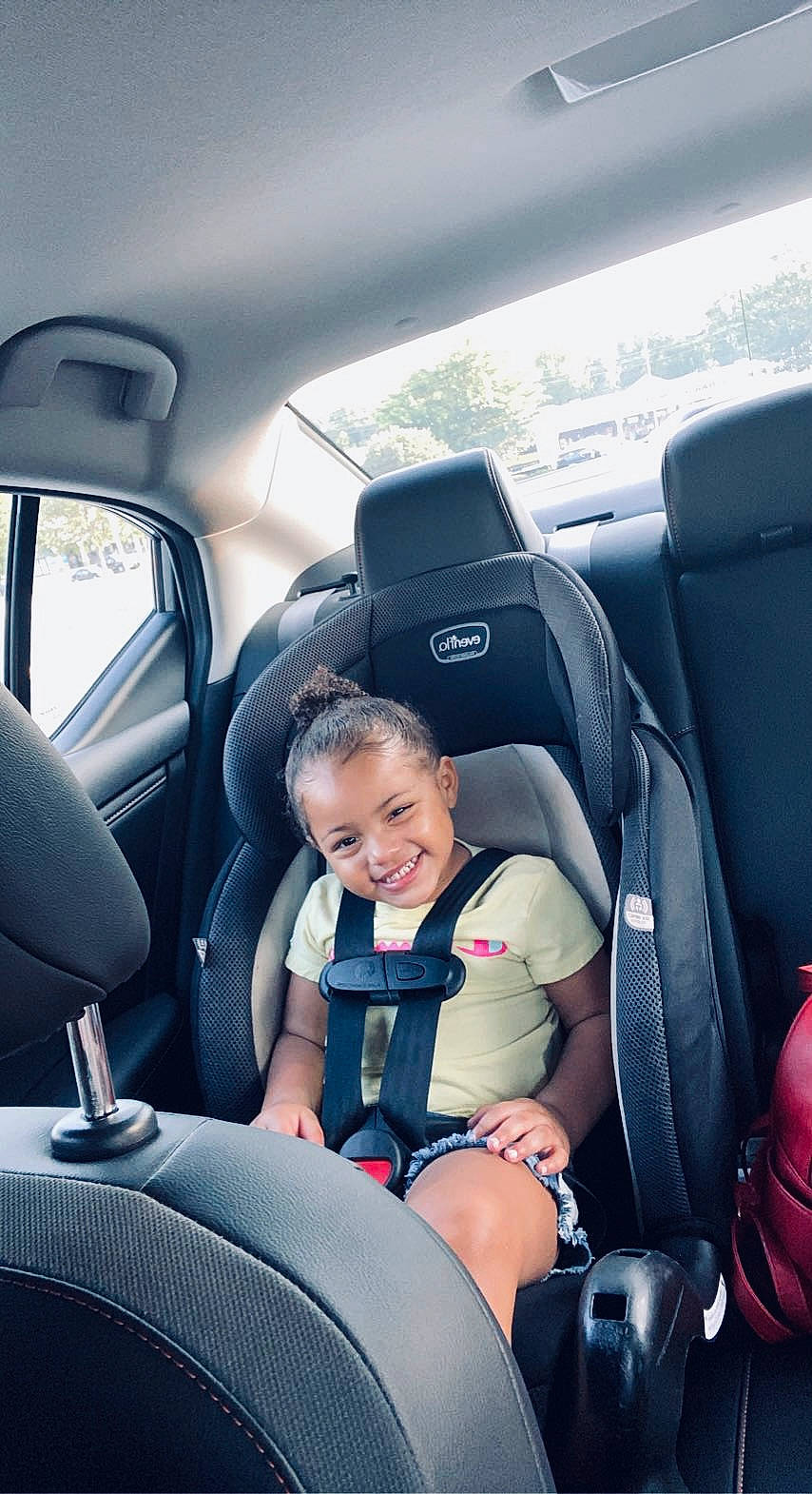 Braylee is registered to the contest to win money with this photo: auto_part, automotive_design, automotive_exterior, car, car_seat, car_seat_cover, comfort, head_restraint, joy, mode_of_transport, motor_vehicle, person, personal_luxury_car, plant, seat_belt, smile, steering_part, steering_wheel, toddler, vehicle