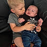 adorable, baby, bare_feet, black_couch, brother, child, couch, cuddling, denim, family, home, indoor, infant, kiss, onesie, portrait, siblings, sitting, smiling, toddler
