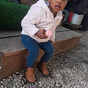 Kailane a rejoint le concours — aidez-le/la à gagner de superbes lots ! toddler, child, outdoor, sitting, wooden_step, jacket, leggings, boots, bottle, gravel, curious, person, young_child, casual_clothing, daylight, candid, portrait, small_object, natural_light, playful