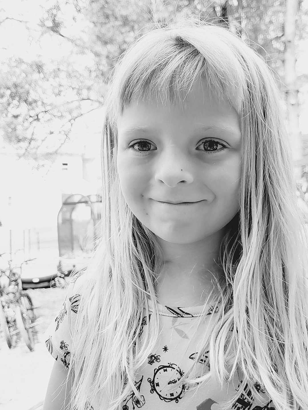 Patience is registered to the contest to win money with this photo: black, black_and_white, child, chin, eye, eyebrow, face, flash_photography, hairstyle, happy, human, iris, joy, lip, long_hair, monochrome, monochrome_photography, person, skin, smile