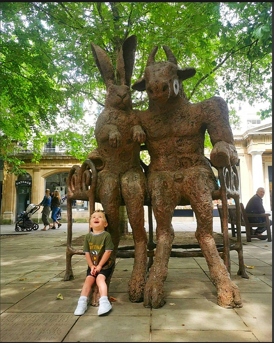 Rex is registered to the contest to win money with this photo: art, blurred, botany, carving, chainsaw_carving, fictional_character, hand, leisure, metal, monument, nonbuilding_structure, person, plant, sculpture, standing, statue, temple, tree, trunk, vacation