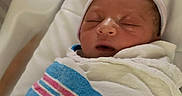John joined the competition — help win amazing prizes! newborn, baby, sleeping, hospital, blanket, bassinet, hat, infant, wrapped, peaceful, cute, portrait, child, person, hospital_room, resting, face, skin, head, maternity
