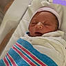newborn, baby, sleeping, hospital, blanket, bassinet, hat, infant, wrapped, peaceful, cute, portrait, child, person, hospital_room, resting, face, skin, head, maternity