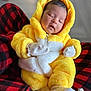 baby, sleeping, costume, yellow, white, fluffy, hood, mittens, socks, red, black, checkered, blanket, infant, cute, resting, soft, cozy, indoor, portrait