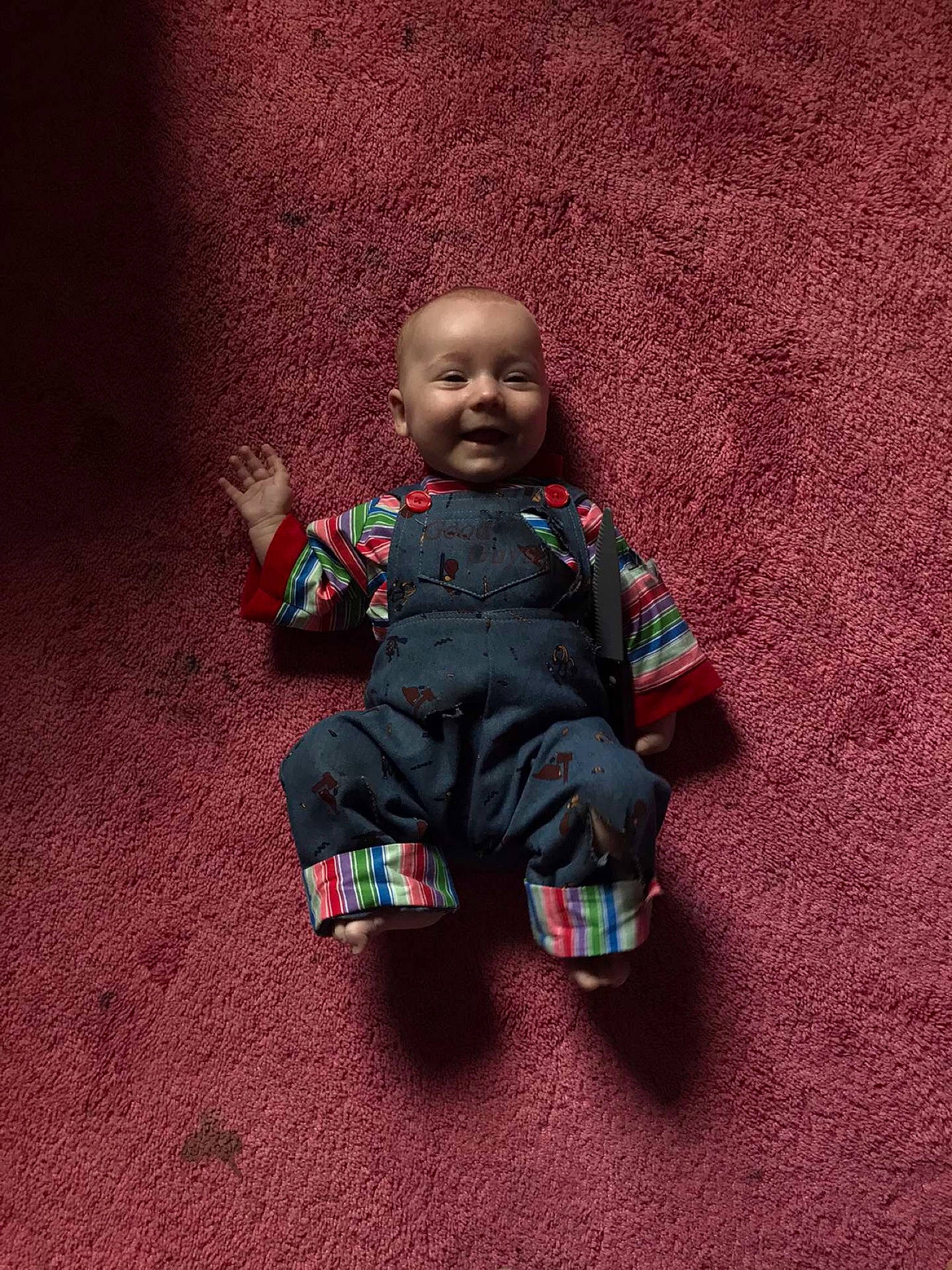 Faye is registered to the contest to win money with this photo: adaptation, child, green, head, person, play, sitting, smile, toddler, toy