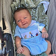 Sutton joined the competition — help win amazing prizes! baby, infant, stroller, blanket, clothing, blue_dress, smile, face, hand, foot, person, child, cute, comfort, seated, portrait, outdoor, fabric, soft, happy