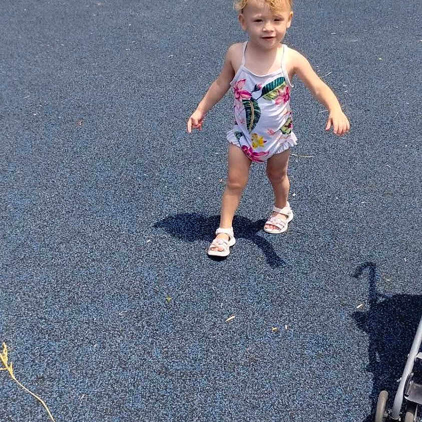 Violet-Jo joined the competition — help win amazing prizes! toddler, child, playground, swimsuit, blue_surface, outdoor, sunny, stroller, walking, tree, grass, sidewalk, car, shadow, summer, person, young_child, happy, playing, park