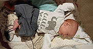 Wyatt is registered to the contest to win money with this photo: baby, bed, blanket, child, clothing, cozy, cushion, cute, elephant_graphic, indoor, infant, infant_boy, lying_down, pillow, portrait, resting, sleepwear, soft_toys, white_shirt, young_child