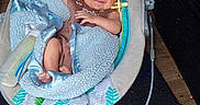 Wyatt joined the competition — help win amazing prizes! baby, infant, blanket, blue, bottle, baby_rocker, floor, wooden_floor, smiling, happy, indoors, cozy, child, person, cute, relaxed, baby_garment, baby_toy, bright_starts, home
