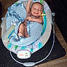 Wyatt is registered to the contest to win money with this photo: baby, baby_rocker, blanket, blue, bottle, child, comfort, cozy, cute, fabric, happy, indoor, infant, person, relaxing, seat, small, smile, toy, wooden_floor