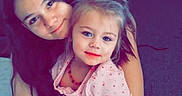 River Grace is registered to the contest to win money with this photo: affection, blanket, carpet, casual, child, childhood, couch, family, furniture, girl, home, hug, indoor, people, portrait, room, sibling, smile, toddler, together