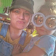 River Grace is registered to the contest to win money with this photo: woman, child, glasses, indoor, selfie, playful, casual, hat, denim_overalls, yellow_shirt, blue_shirt, fun, portrait, face, people, light, colorful, smile, holding, young_child