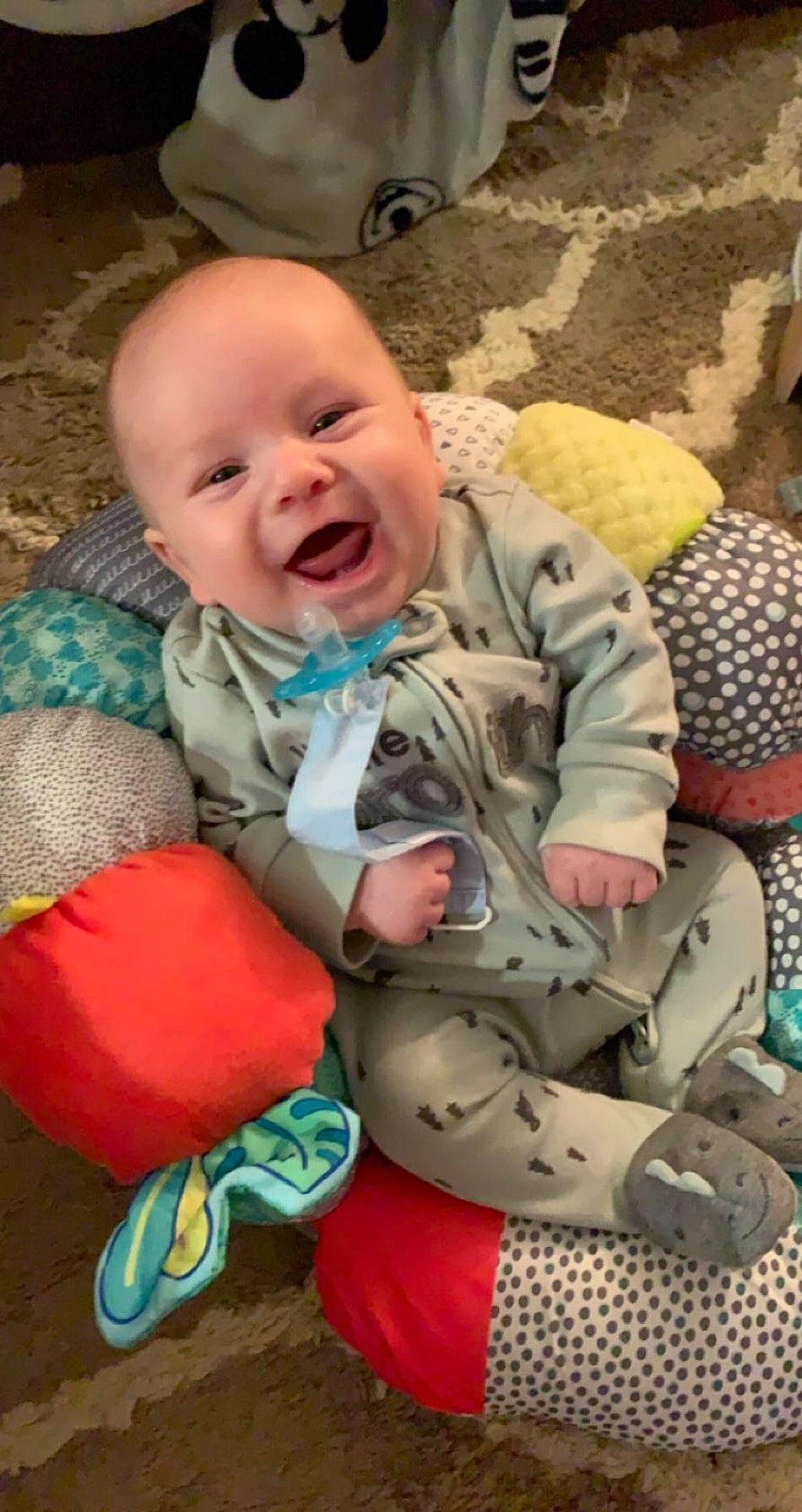 Valen is registered to the contest to win money with this photo: baby, baby_products, baby_toddler_clothing, camouflage, cheek, child, comfort, eye, face, fun, grass, happy, head, linens, military_camouflage, pattern, person, sitting, skin, smile