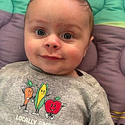 Morgan joined the competition — help win amazing prizes! baby, child, infant, onesie, locally_grown, clothing, face, eyes, smile, cheeks, hair, blanket, quilted_blanket, toy, lying_down, portrait, closeup, cute, nursery, cartoon_vegetables