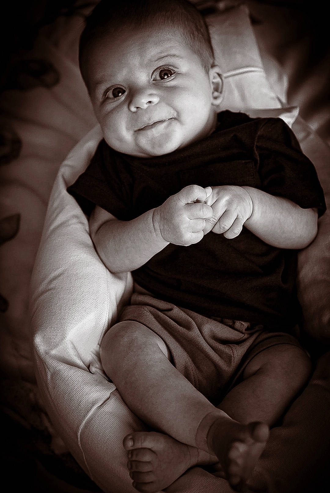 Easton is registered to the contest to win money with this photo: arm, baby, bodypart, clothing, couch, face, finger, frown, furniture, glove, hand, happy, head, newborn, person, photography, portrait, sitting, smile, wrist