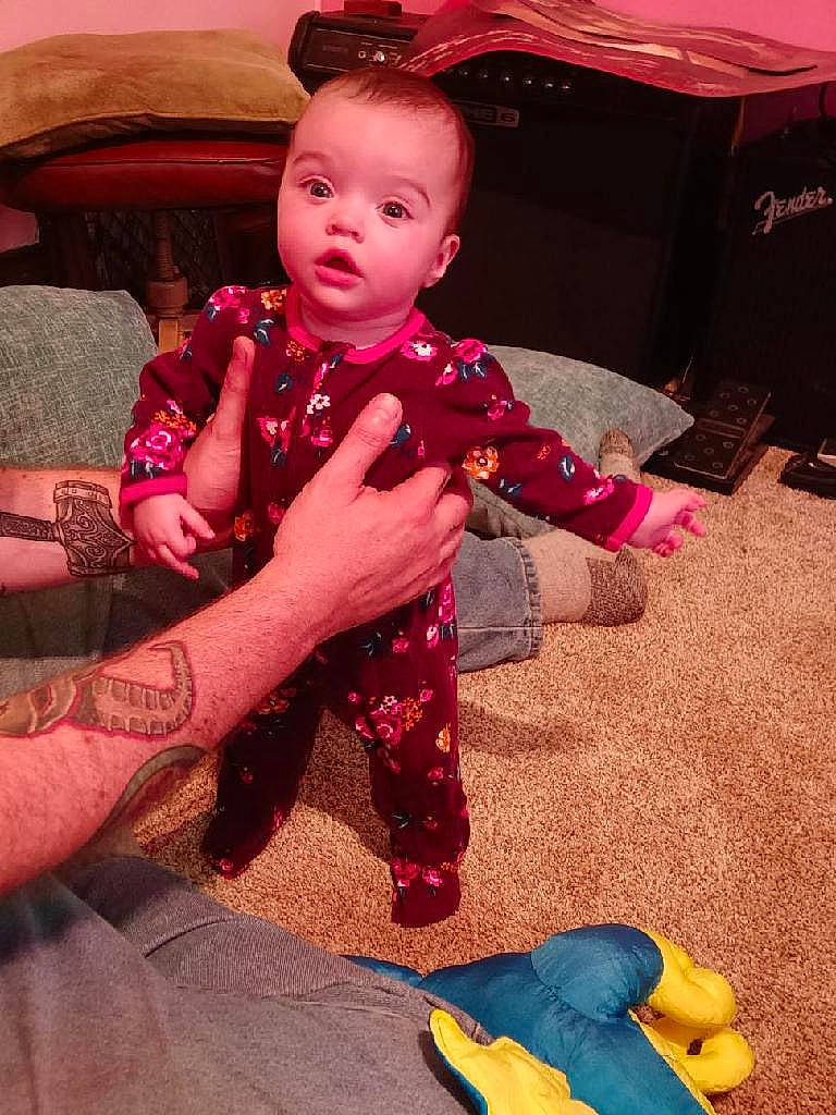 Bexley is registered to the contest to win money with this photo: baby, baby_toddler_clothing, black, child, comfort, finger, fun, happy, head, lap, mouth, organ, person, photograph, pink, red, skin, snapshot, textile, toddler