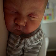 Westin is registered to the contest to win money with this photo: newborn, baby, sleeping, infant, striped_clothing, cozy, soft_light, portrait, close_up, peaceful, child, face, blanket, indoors, resting, cute, toddler, skin, warm, quiet