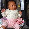 baby, infant, car_seat, clothing, bottle, blanket, pink_pants, polka_dots, cute, child, portrait, indoor, seatbelt, newborn, baby_girl, adorable, soft_lighting, baby_accessories, resting, young_child