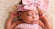 Iyla is registered to the contest to win money with this photo: newborn, baby, sleeping, pink_bow, blanket, infant, headband, cute, soft_texture, fluffy, peaceful, resting, portrait, closeup, skin, arms, head, face, indoors, cozy