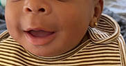 Iyla joined the competition — help win amazing prizes! baby, infant, child, portrait, close_up, smiling, happy, face, eyes, striped_bib, clothing, earring, indoor, home, bed, blanket, furniture, photography, adorable, hungry
