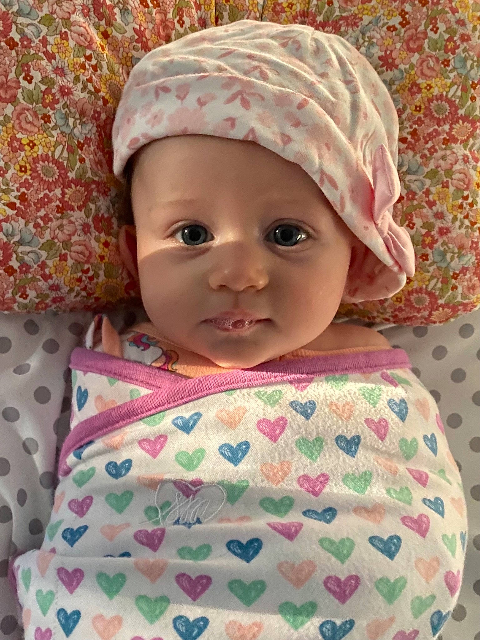 Lakyn is registered to the contest to win money with this photo: baby, baby_toddler_clothing, cap, cheek, dress, face, happy, head, headgear, headwear, human_body, lip, outerwear, pattern, person, pink, product, skin, sleeve, textile