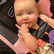 Paisley is registered to the contest to win money with this photo: baby, infant, child, stroller, pink, black, seatbelt, hand, fingers, curious, clothing, flamingo, pattern, shopping_cart, cute, portrait, indoor, seat, face, expression