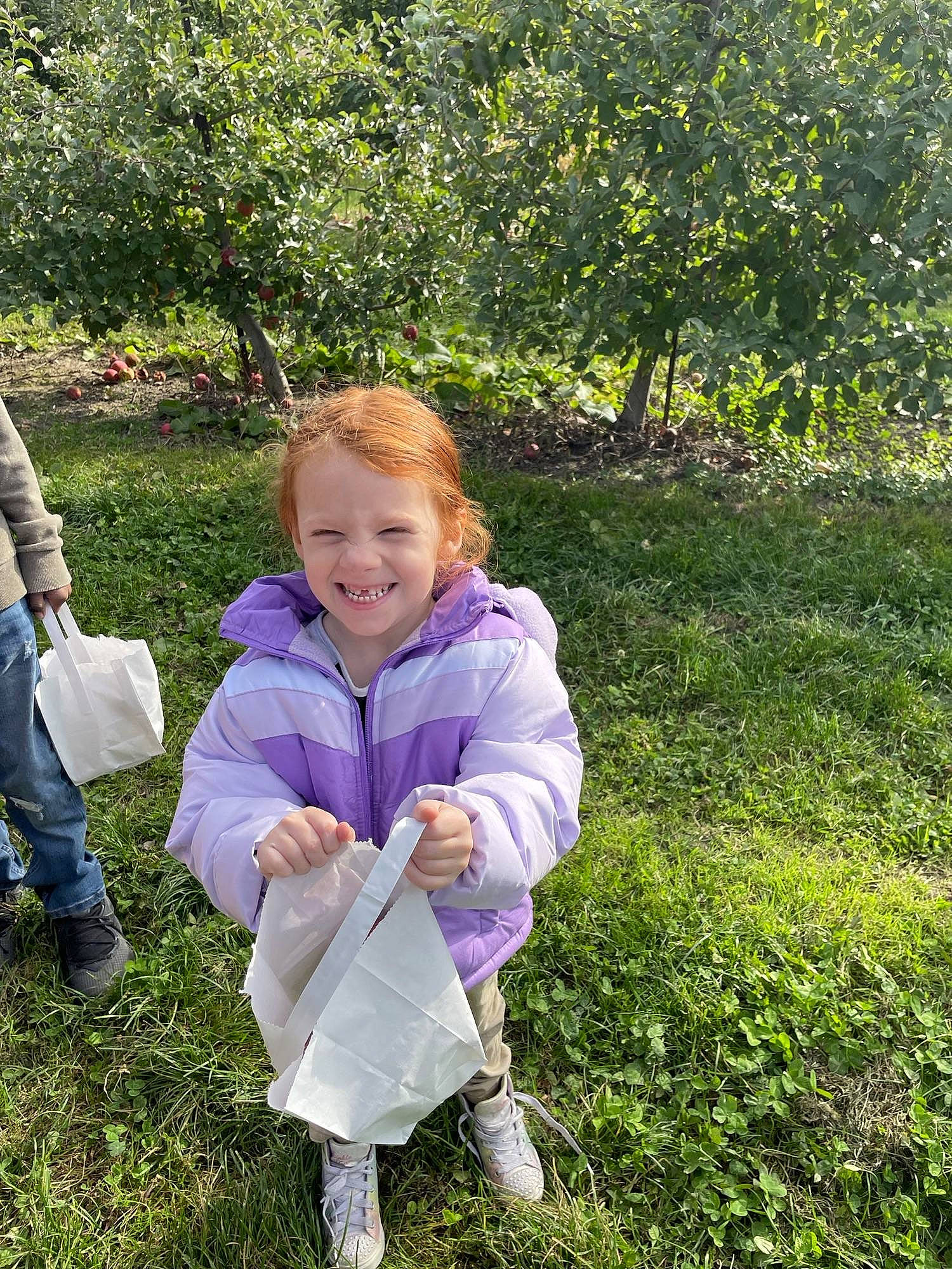 Alaya is registered to the contest to win money with this photo: baby_toddler_clothing, child, fun, gesture, grass, grassland, happy, joy, lawn, leisure, luggage_and_bags, meadow, natural_landscape, people_in_nature, person, plant, prairie, recreation, smile, sneakers