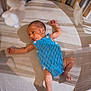 baby, newborn, crib, blue_romper, sleepwear, infant, sleeping_area, wooden_crib, soft_lighting, shadow, peaceful, indoors, cute, small, lying_down, child, portrait, baby_clothes, resting, newborn_baby